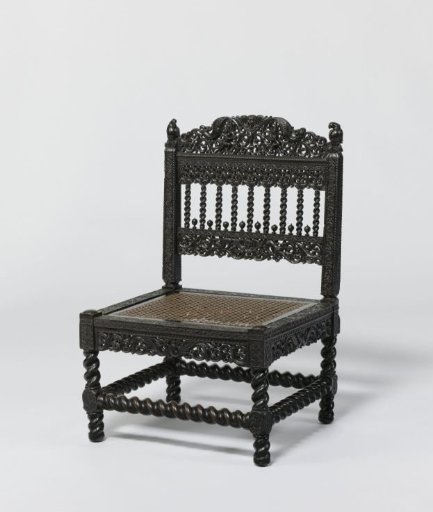 Chair with parrot-like birds on the back splats