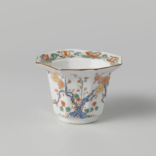 Bowl with two birds near a flowering plant