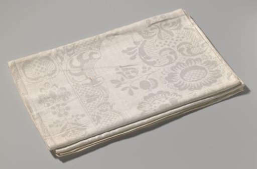 Tablecloth of linen damask with large floral pattern and a lace pattern