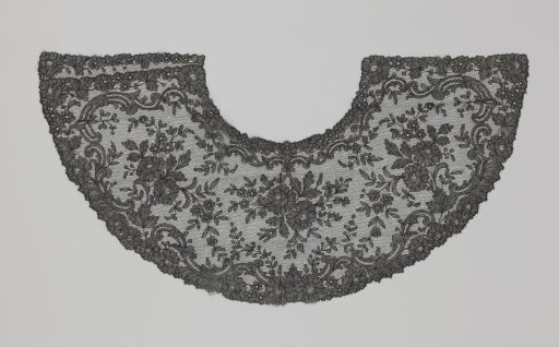 Fan leaf of black bobbin lace with three large flower branches