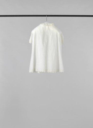 A child's jacket of batiste with embroidered borders.