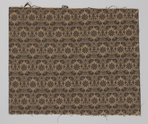 Fragment of upholstery fabric with a flower within a pointed oval