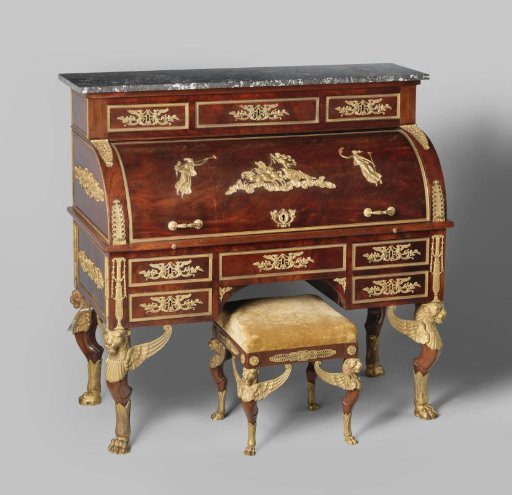 Desk veneered with mahogany and resting on lion's paw feet of bronze that transition into winged lion heads. With drawers, pull-out writing surface, flap, and marble top.