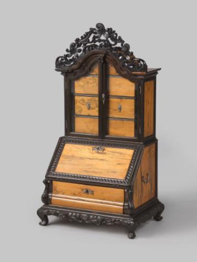 Upright cabinet with two doors and glazed panels concealing drawers, part of a desk