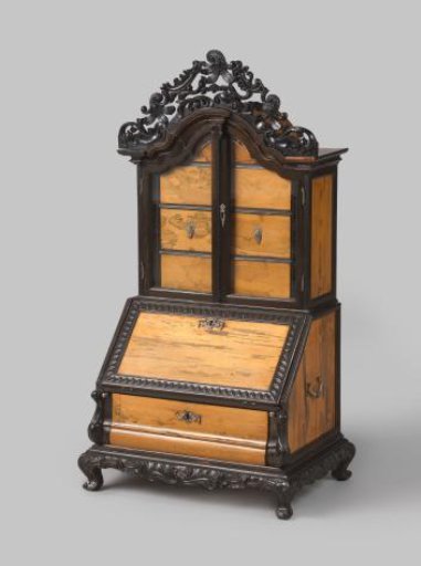 Double-curved lower cabinet with a drawer, part of a desk; upper section with a sloping flap and reeded edge; silver mounts