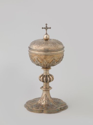 Ciborium decorated with leaf motifs in relief.