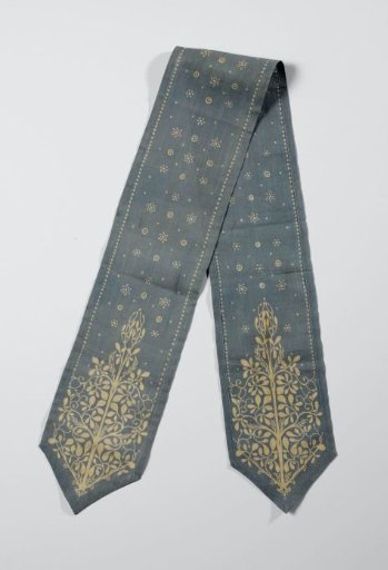 Blue bookmark with a batik pattern, including a tree motif in the pointed ends
