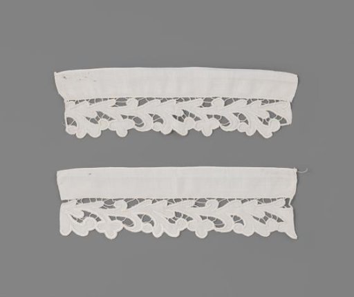 Linen cuff with Richelieu work, with a running pattern of projecting leaf forms with volute branches