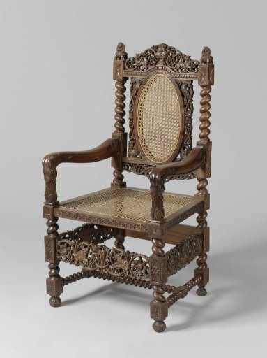 Armchair with rattan seat, decorated with rosettes and twisted elements, with an openwork crest on the arched top rail, armrests ending in elephant-like heads