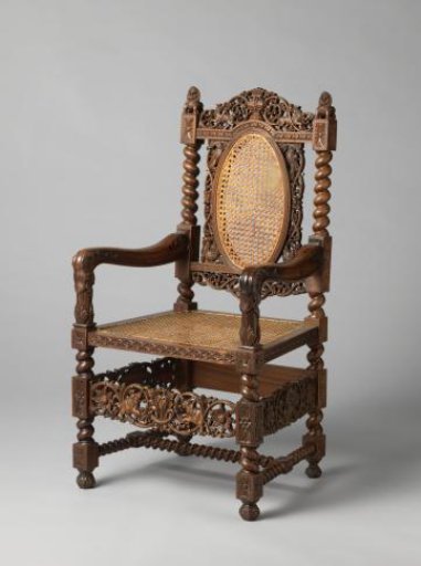 Armchair with rattan seat, decorated with rosettes and twisted elements, with an openwork crest on the arched top rail, armrests ending in elephant-like heads