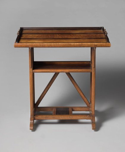 Tea table with a removable serving tray and openwork side panels in a bean motif