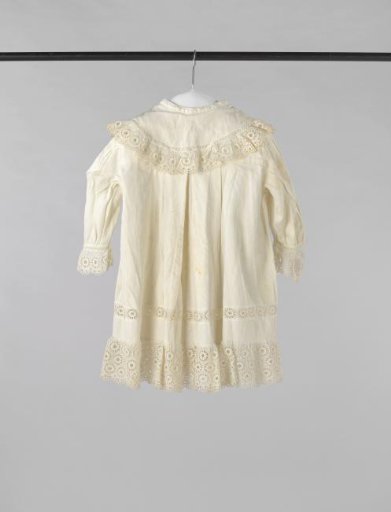Child's jacket of white twill cotton with a hanging round collar and decorated with English embroidery.