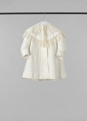 A wagon jacket of white twill cotton with a pelerine collar, and decorated with open machine lace