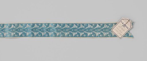 Ribbon of blue (warp) and white (weft) silk; a continuous pattern in white applied on a blue background