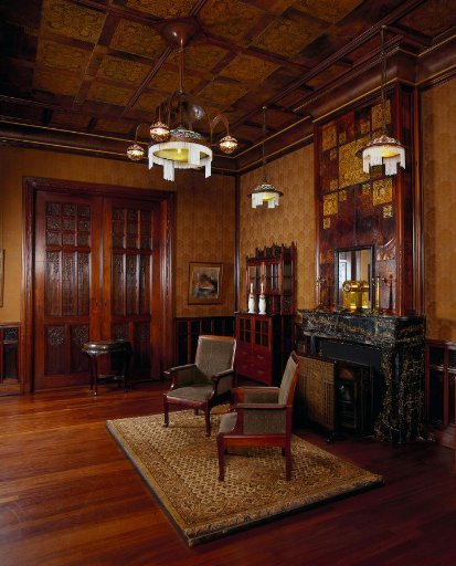 Wall paneling consisting of a half-height wainscoting, a double and a single door with their frames, fireplace surround, ceiling, and upholstery fabric