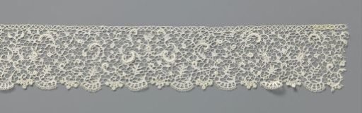 Strip of needle lace with corded C-scrolls
