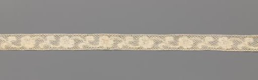 Strip of bobbin lace with linked wavy flower stems with one flower