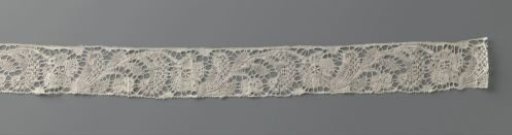 Bobbin lace strip with linked curved flower stems