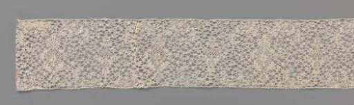 Strip of bobbin lace with a candelabrum motif