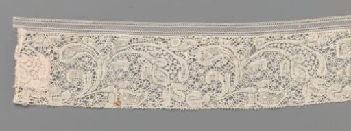 Strip of bobbin lace with flower stem with three linked flowers