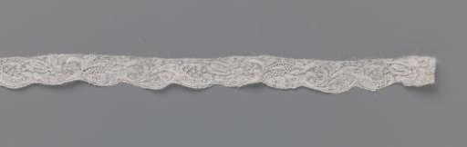Strip of bobbin lace with feather-shaped flower and star-shaped flower