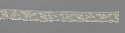 Strip of needle lace with linked flowers