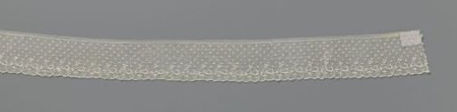 Strip of needle lace with dots
