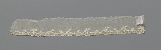 Strip of machine-made lace with a rococo border of needle lace
