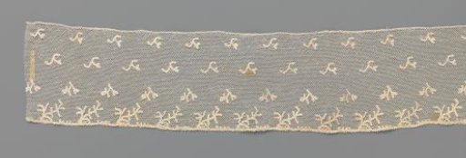 Strip of bobbin lace with a scatter pattern of inverted V-shaped sprigs