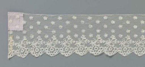 Strip of bobbin lace with a delicate branch and a hanging cluster of rosette flowers or forget-me-nots