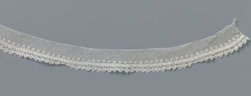 Strip of bobbin lace with three lengthwise stripes