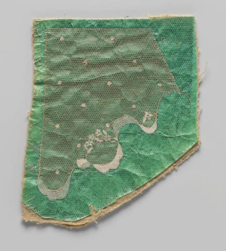Work in progress of needle lace on green pricking with linen backing
