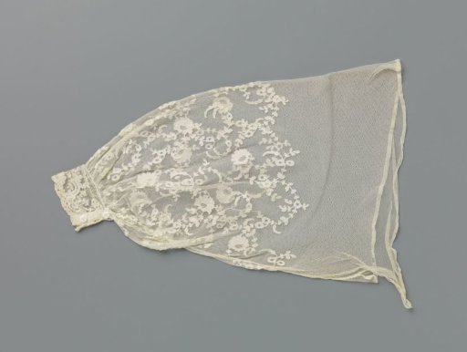 Under-sleeve of appliqué lace with curling flower branches under a wavy floral garland