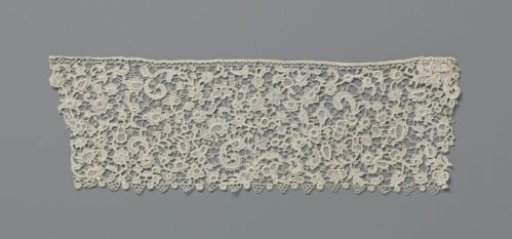 Strip of needle lace with C-scrolls and various flowers