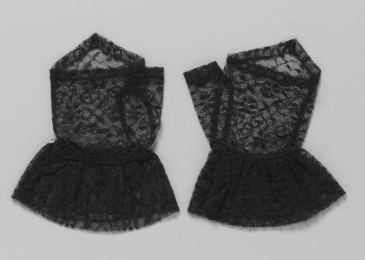 Black machine lace mitten with curling open C-scrolls and stylized flowers with six loose petals