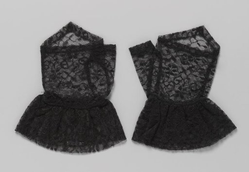 Mitten of black machine-made lace with a point on the back of the hand and a ruffled strip around the wrist