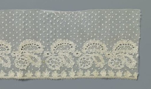 Strip of machine-made lace with rosette flower under two large oval leaves
