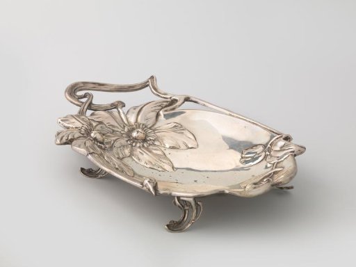 Silver oval dish, decorated with a stem of clematis with foliage and two large flowers in relief