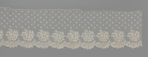 Strip of cutwork appliqué with a scattered pattern and curved flower branches on one side