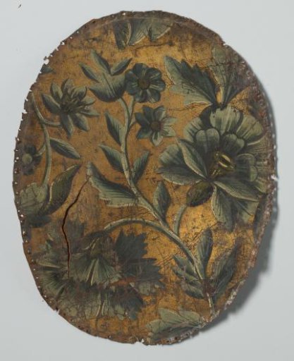 Backrest of a chair in gold leather with a pattern of flowers
