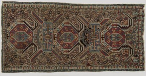 Medallion carpet with three octagonal medallions in the central field against a black ground