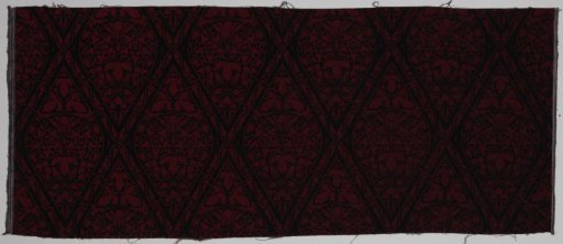 Hand-printed calico with design "Delphinium" in black on a red ground