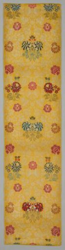 Weave of woolen grain, multicolored flowers on a yellow ground with a pattern of branches, leaves, and flowers in white