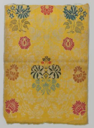 Weave of woolen grein, multicoloured flowers on a yellow ground with a pattern of branches, leaves and flowers in white