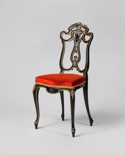Chair, painted alternately glossy and matte black, decorated with gilded edges and some gold-colored metal fittings. Upholstered in orange velvet.