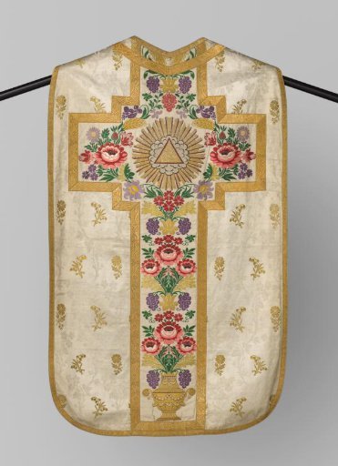 Chasuble of white brocade: on the back cross a woven triangle in a sunburst with naturally colored grapes and roses in a vase