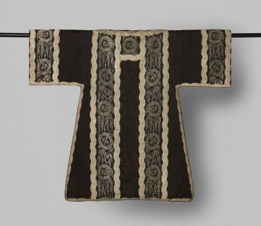 Dalmatic of black brocade silk with woven floral patterns and embroidery