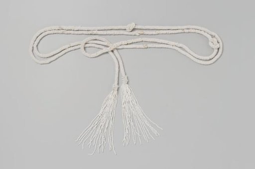 Necklace or belt of a long cord entirely set with white beads, two long bead tassels at the ends