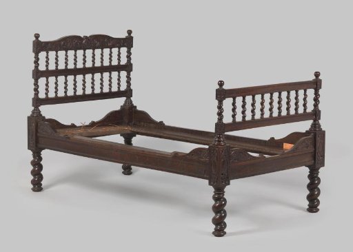 Bed of wood with twisted legs and stiles decorated with dolphins and acanthus leaves