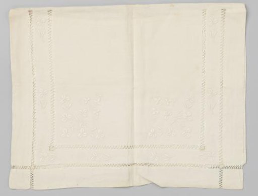 Black bag of fine linen, decorated on the flap with white embroidery with open hems and clover leaves.